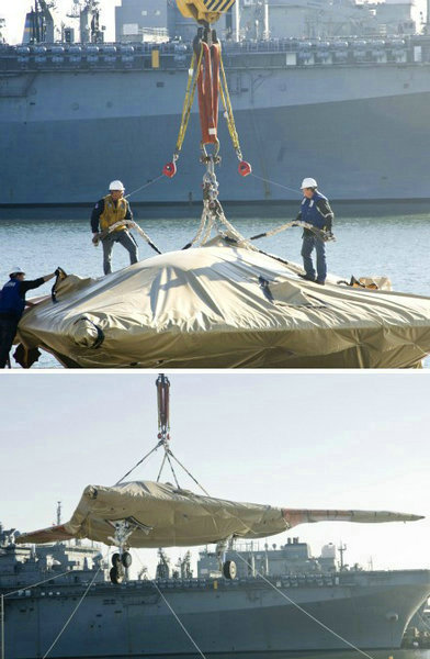 資料圖：美國海軍人員將一架X-47B無人空戰(zhàn)系統(tǒng)驗證機運送到杜魯門號航母上。