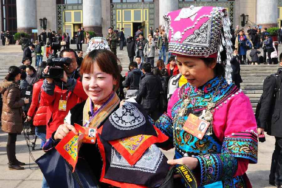 云南代表團的兩位女代表在為記者展示她們帶來的民族特色手工藝品。 人民網(wǎng)記者 馬麗婭 攝