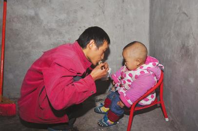 詹圓圓出門前給兒子喂飯。